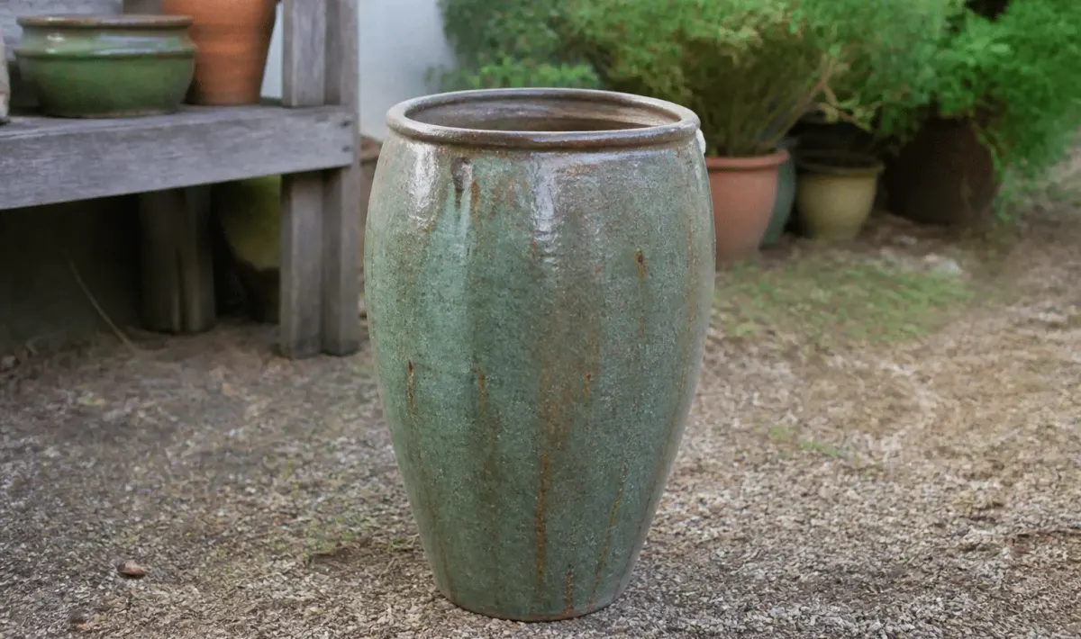 Large ceramic planter standing upright on garden ground surface